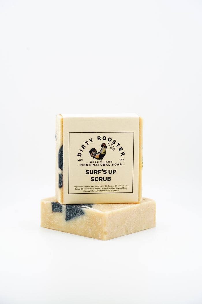 Surfs Up Scrub handmade natural soap bar for men, wrapped, standing on an unwrapped tan bar